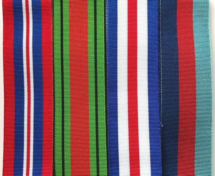 four different colored ribbons are lined up together