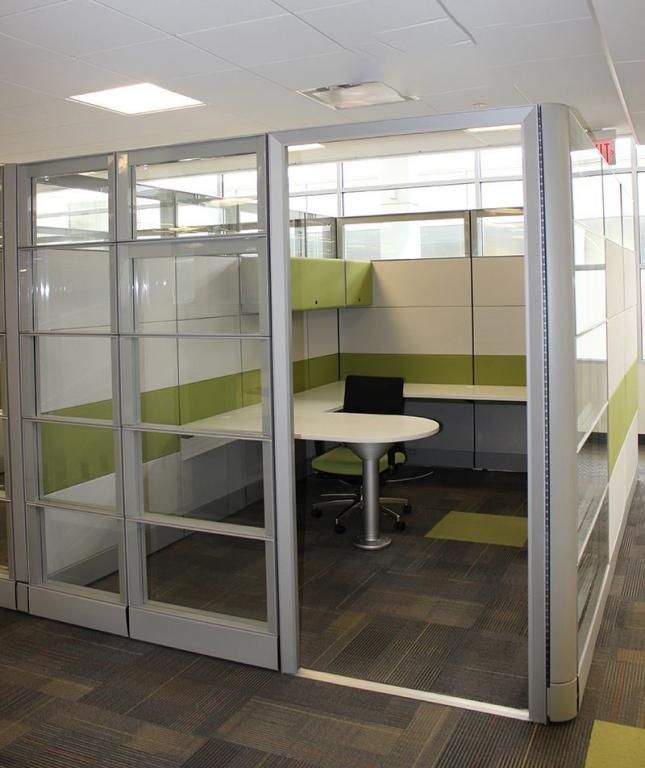 an office cubicle with sliding glass doors and desks