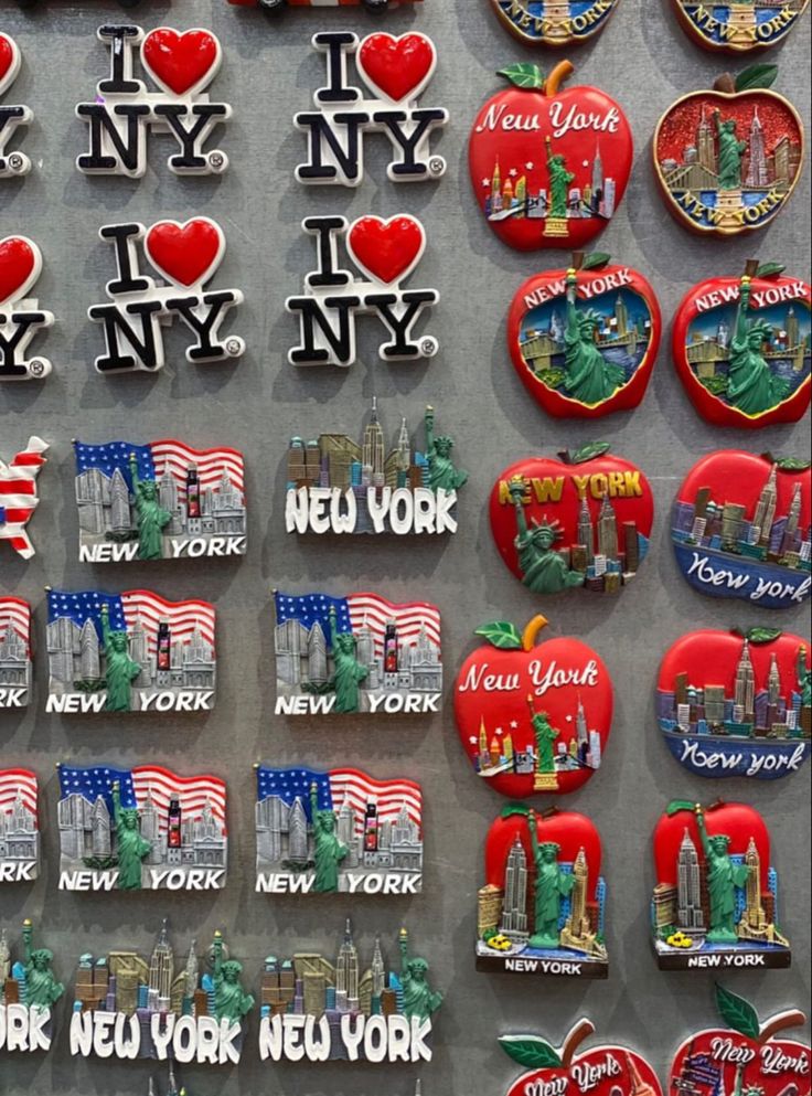 the new york city souvenirs are on display in front of other magnets