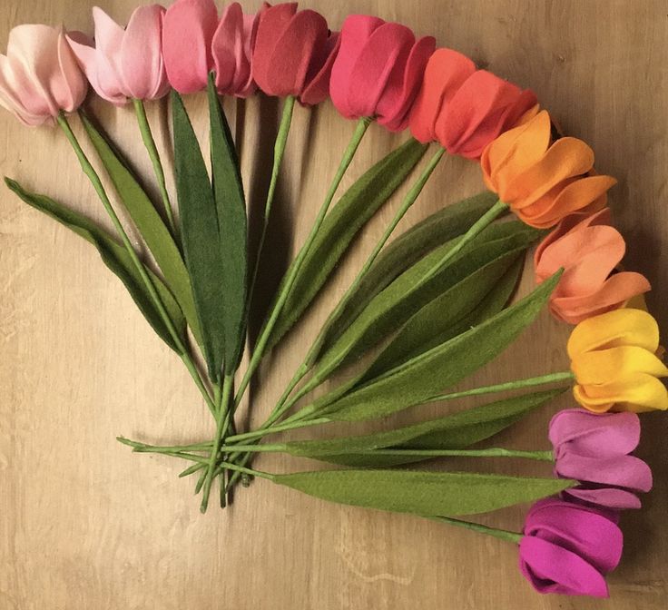 a bunch of flowers that are laying on a table with one flower in the middle