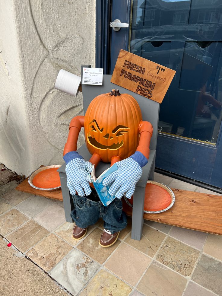 a pumpkin sitting on top of a chair with its hands in his face and mouth