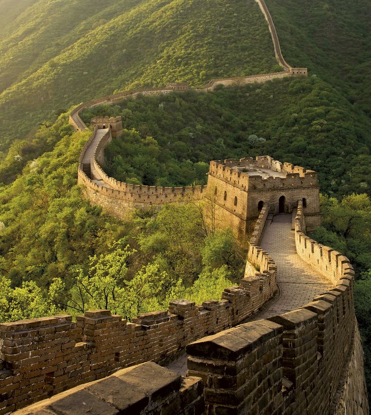 the great wall of china with mountains in the background