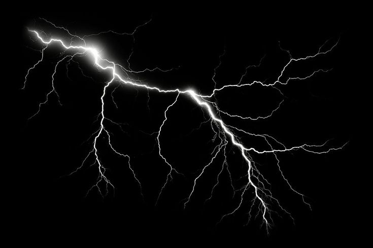 a black and white photo of lightning striking through the night sky with long, thin electrical discharges