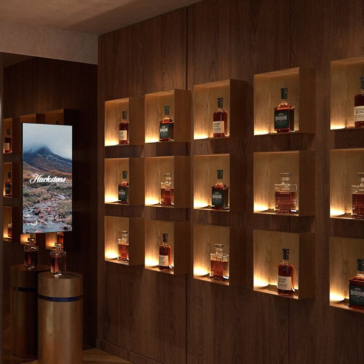 a room with shelves filled with bottles and lights on the wall next to each other