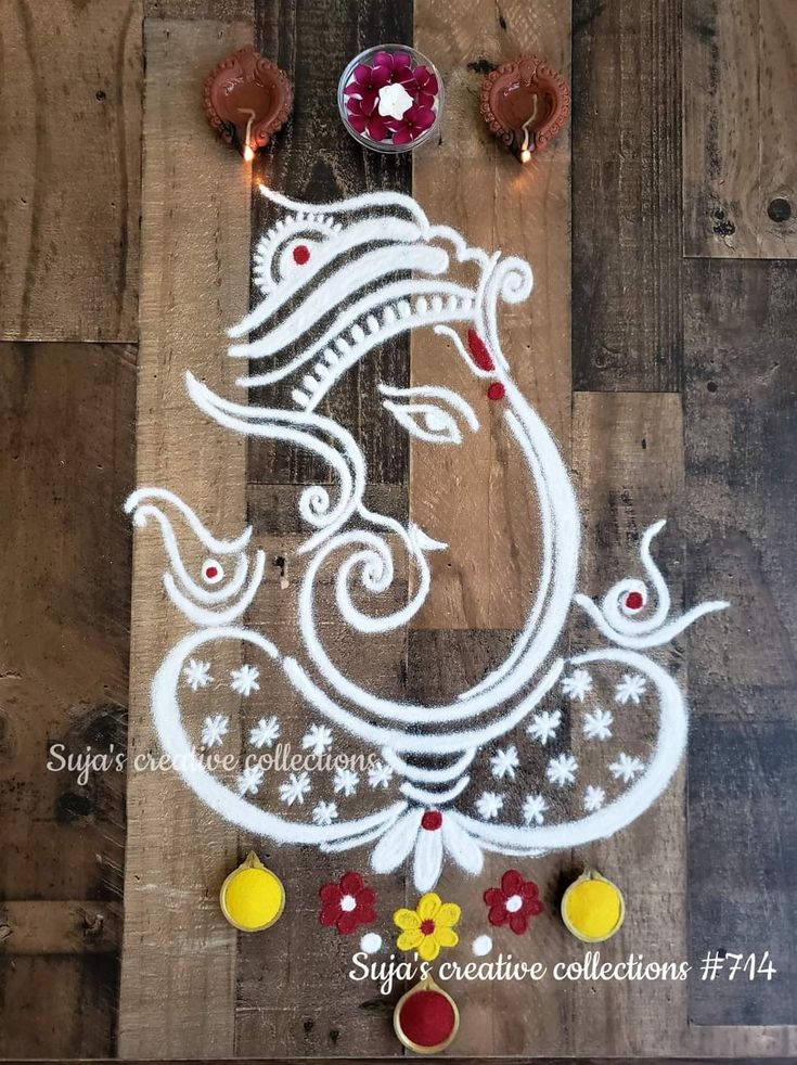 an image of lord ganeshi painted on wooden planks for diwaling