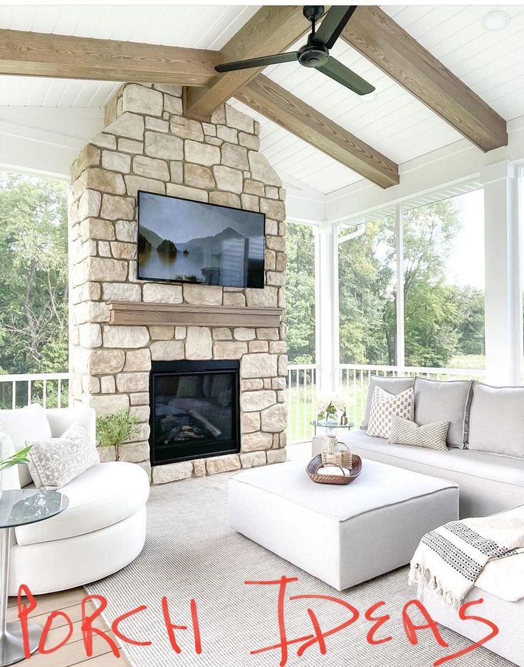 a living room filled with furniture and a flat screen tv mounted on the wall above a fireplace