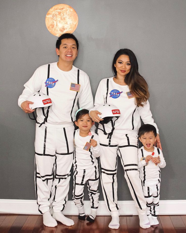 the family is dressed up in space suits