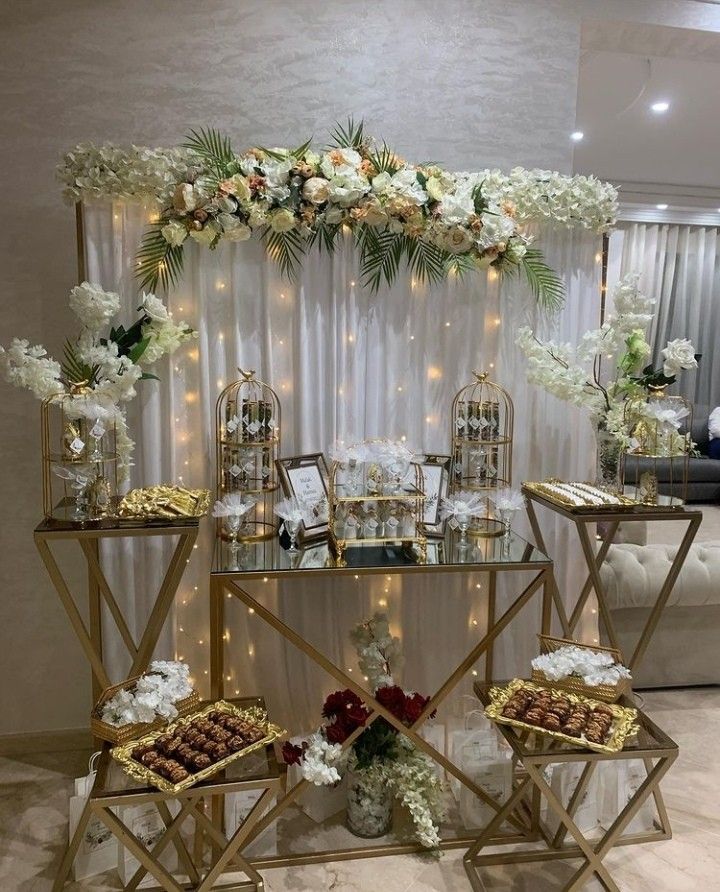 a table set up with flowers and desserts