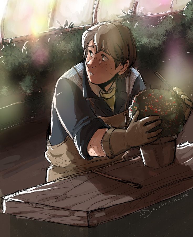 a boy sitting at a table holding a potted plant