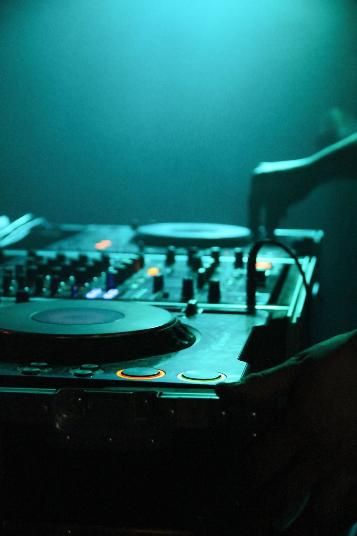 a dj mixing in front of a set of turntables