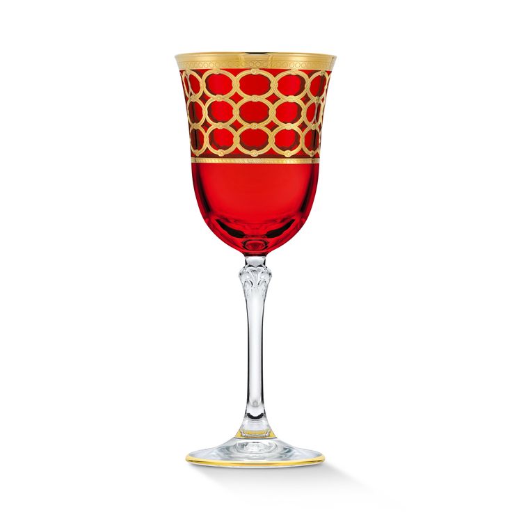 a red wine glass with gold trimmings on the rim and bottom, sitting in front of a white background