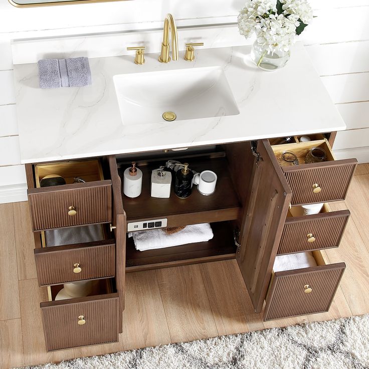 a bathroom vanity with drawers and a sink