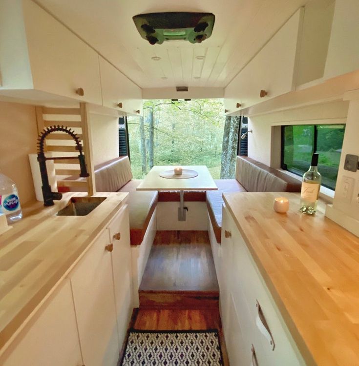 the inside of a camper with wood counter tops