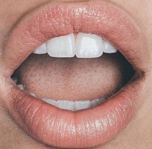 a woman's lips with white teeth