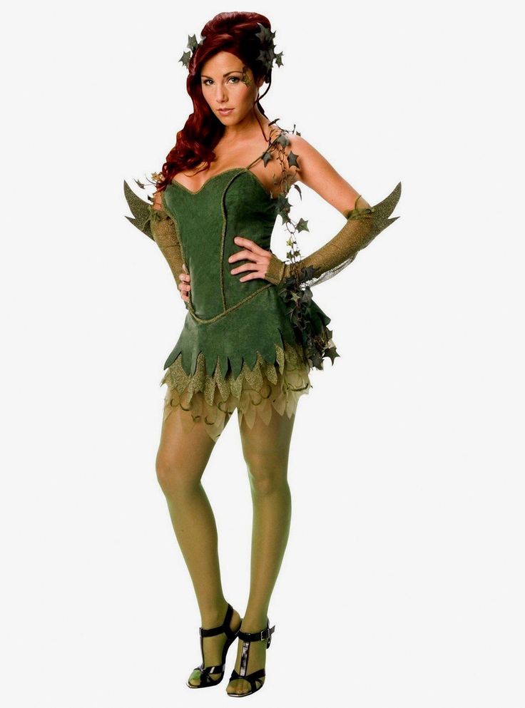 a woman in a green costume is standing with her hands on her hips and looking at the camera