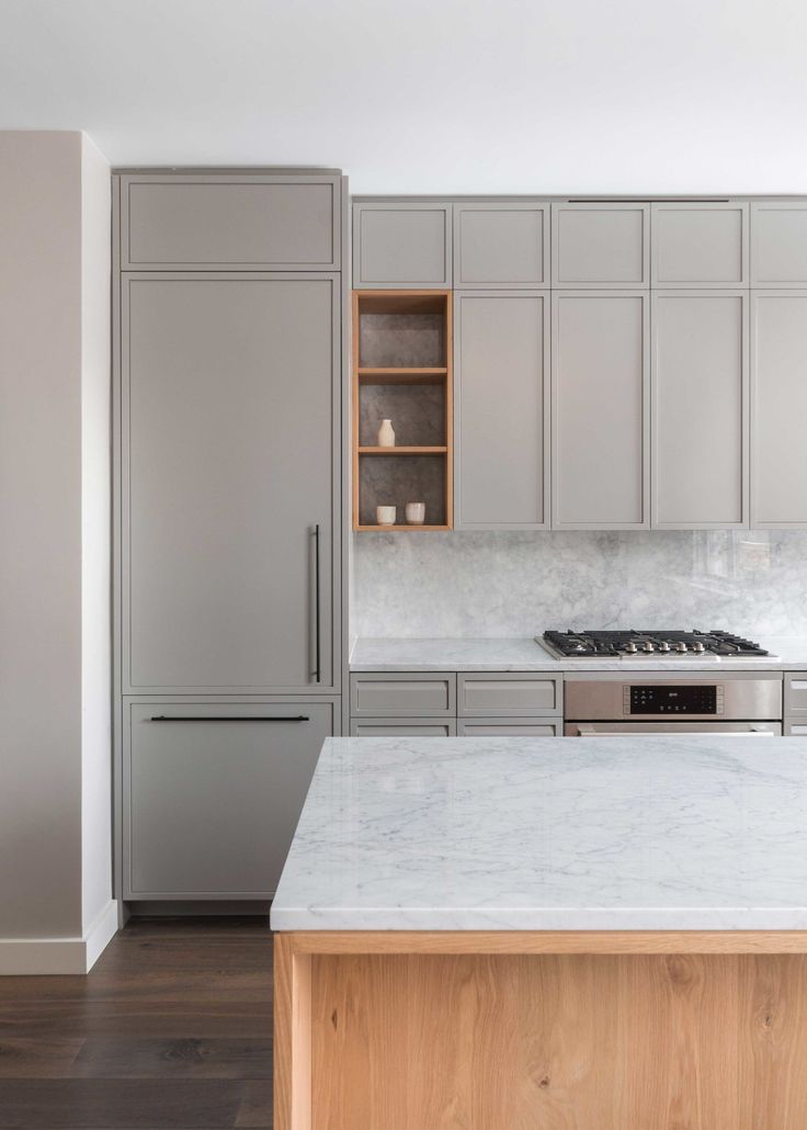 a kitchen with marble counter tops and stainless steel appliances