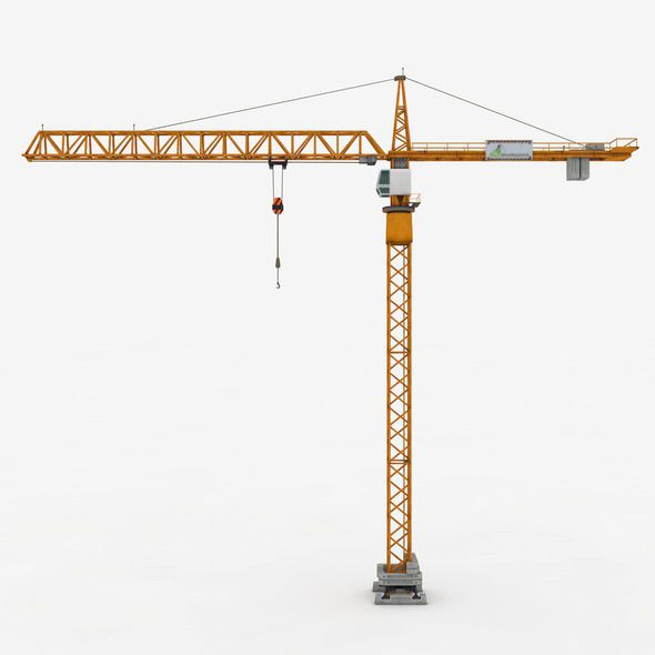 a yellow tower crane is standing in the snow and it's attached to a light pole