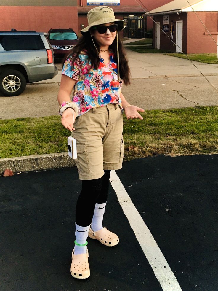 a woman standing in the parking lot with her hands out