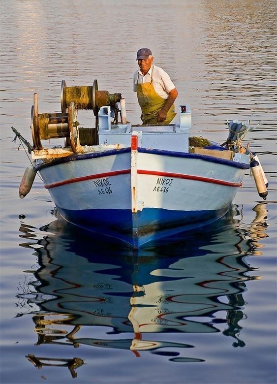 a man standing on top of a boat in the water