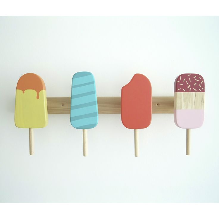 four popsicles are lined up on a wooden stick and one is painted in different colors