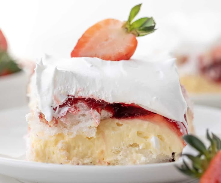 a slice of strawberry shortcake with whipped cream and strawberries on the side, ready to be eaten