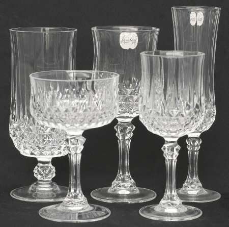 four clear glass goblets on pedestals, all in different sizes and shapes