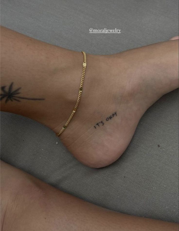 a woman's foot with a gold chain on it and the words it's only written in black ink