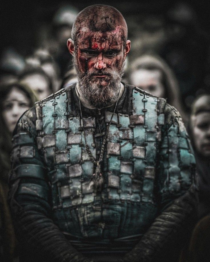 a man with blood all over his face standing in front of a group of people