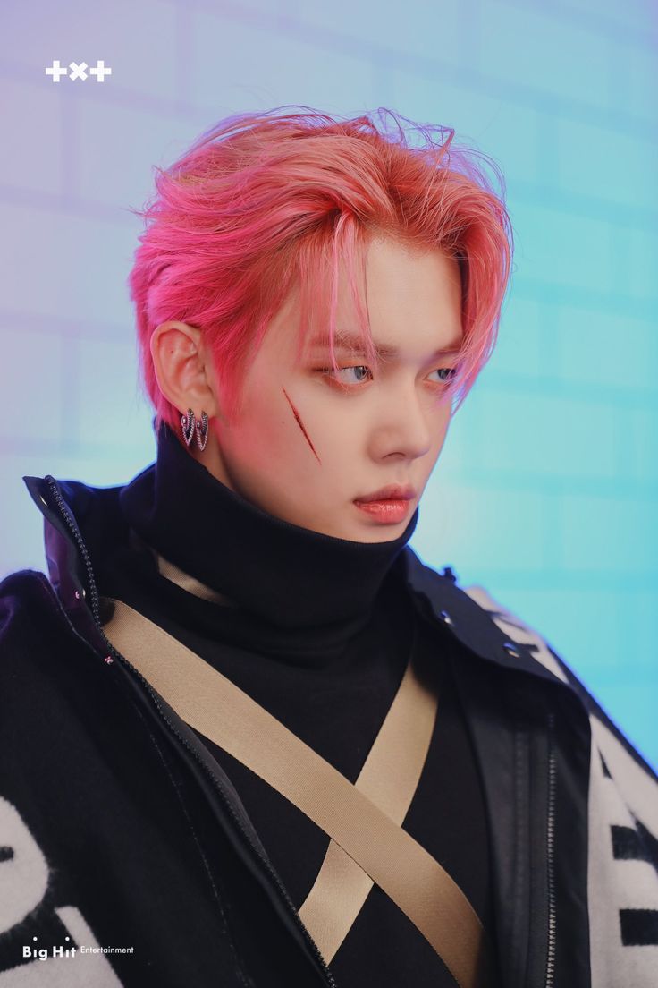 a young man with pink hair and piercings on his ears wearing a black turtle neck sweater