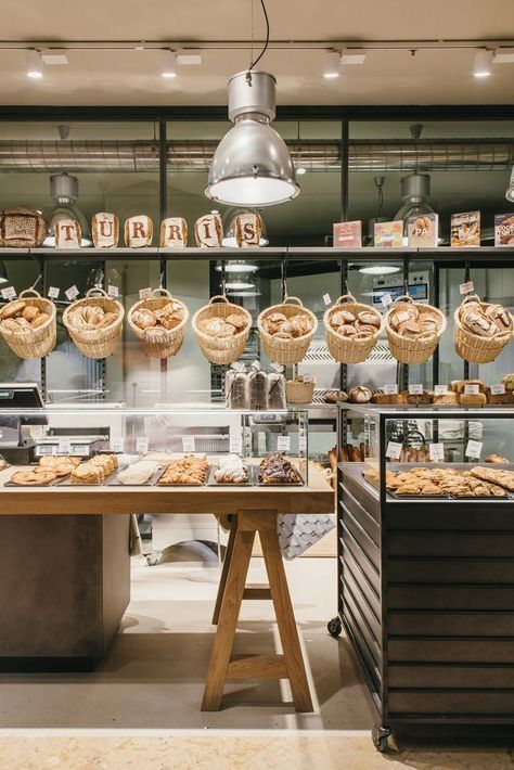 a bakery with lots of breads and pastries hanging from the ceiling in front of it