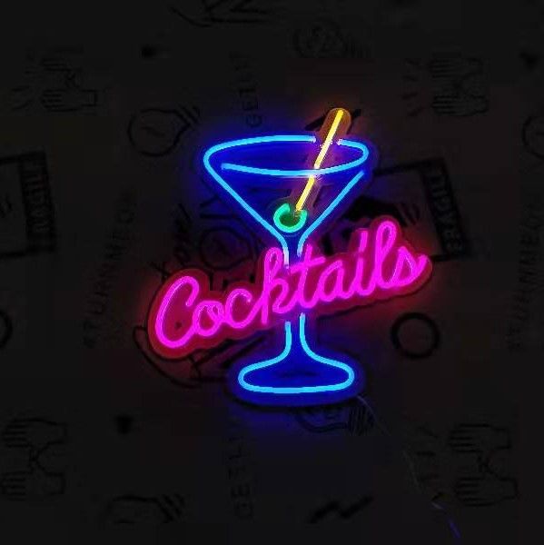 a neon sign that says cocktails on the side of a glass with a straw in it