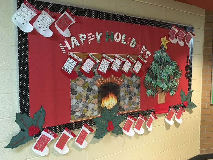 a christmas bulletin board with stockings and stockings hanging from it's sides on the wall