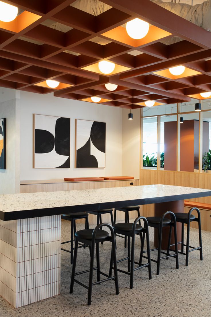 an empty room with tables and stools in it