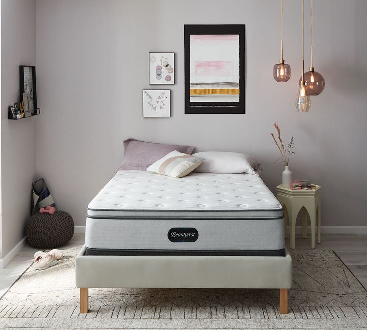 an image of a bedroom setting with the mattress on the bed and nightstand in the corner