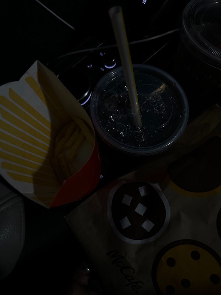 some food is sitting on top of a bag and in front of a cup with a straw