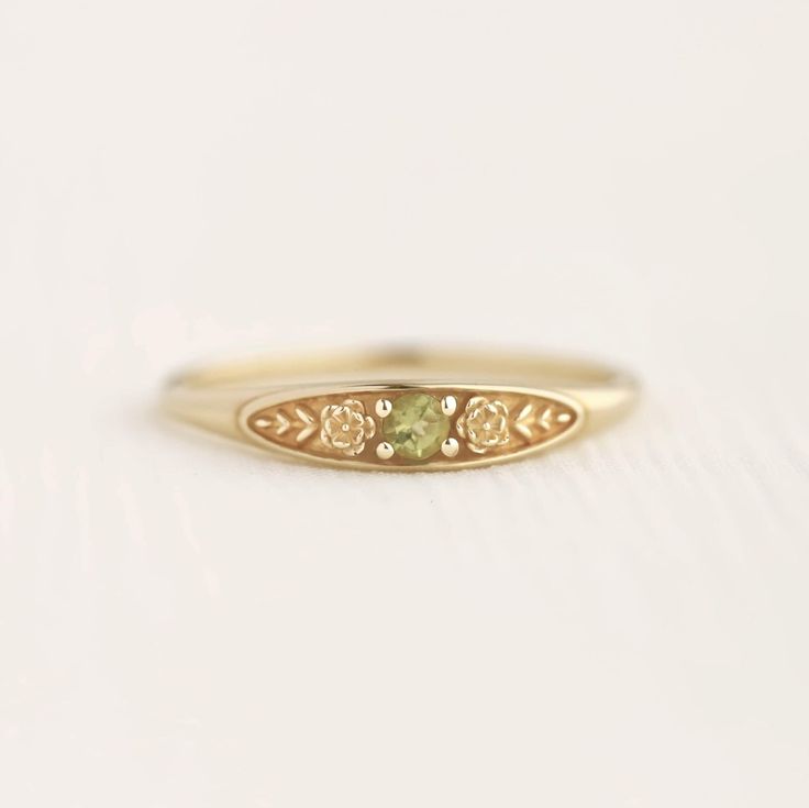 August birth ring This ring will be a very meaningful piece for those born in August . August's birthstone and birth flower are Peridot and Poppy. Greeny peridot and delicately carved poppy will shine and bloom forever. This dainty and slim signet ring is comfortable to wear all the time. This piece will be perfect gift for both to others and yourself. * Detail * Material : 14K solid gold, 18K solid gold, 925 sterling silver Color : Yellow gold, White gold or Rose gold(925 sterling silver is excluded) Stone : Natural Peridot(2.5mm) * Size * Top width : 3.7mm Shank width : 1.2mm Band depth : 2.4-0.9mm * Please check your ring size before ordering, Use this : http://www.onlineconversion.com/ring_size.htm We provide special package with some our business card, guarantee card, gift box. Please Emerald Heirloom Ring, Subtle Promise Rings, September Birth Stone Ring, August Birthstone Rings, Silver Rings With Diamonds, Boho Promise Ring, Metal Work Rings, Gold Floral Ring, Grad Rings College