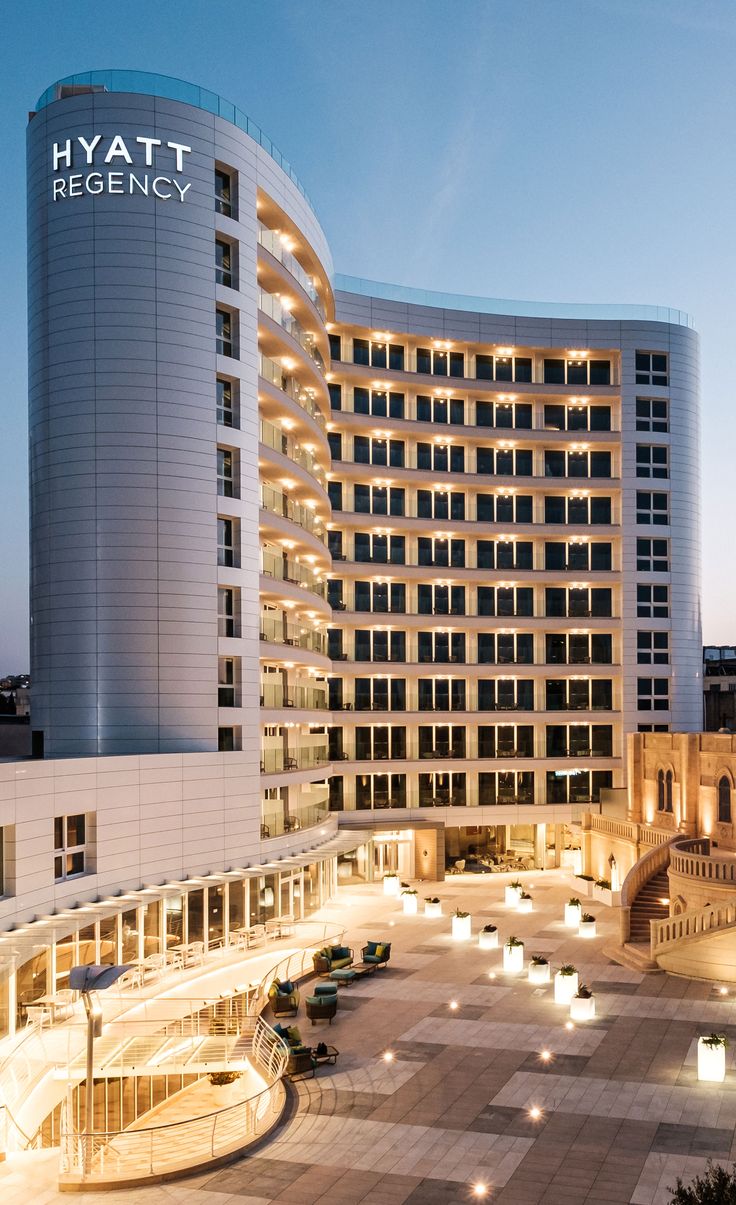 the hyatt regency hotel is lit up at night