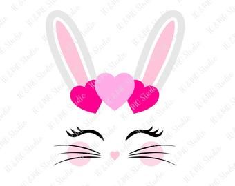 a pink bunny face with hearts on it's ears, and the words love is in