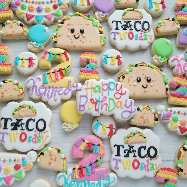 decorated cookies with happy birthday and taco themed words are displayed on a white surface