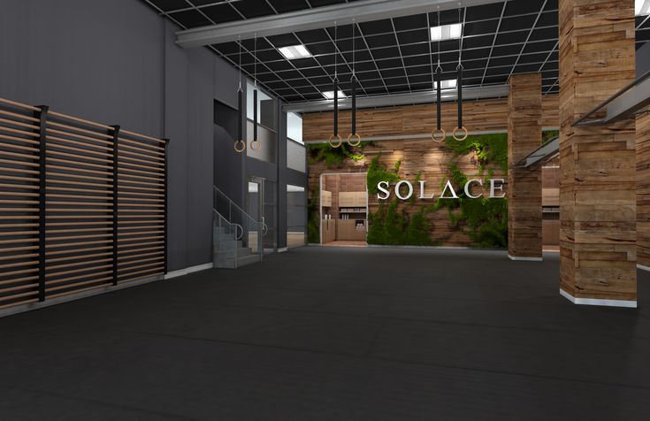 an empty building with wooden slats on the walls and floor, along with a sign that reads solace