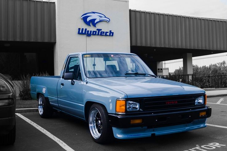 a blue pick up truck parked in front of a walgreen store with an eagle logo on it