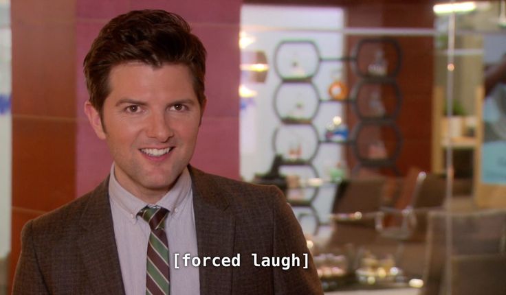 a man in a suit and tie is smiling for the camera while talking to someone