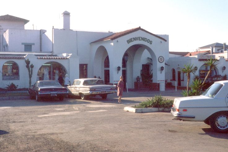 two cars parked in front of a white building