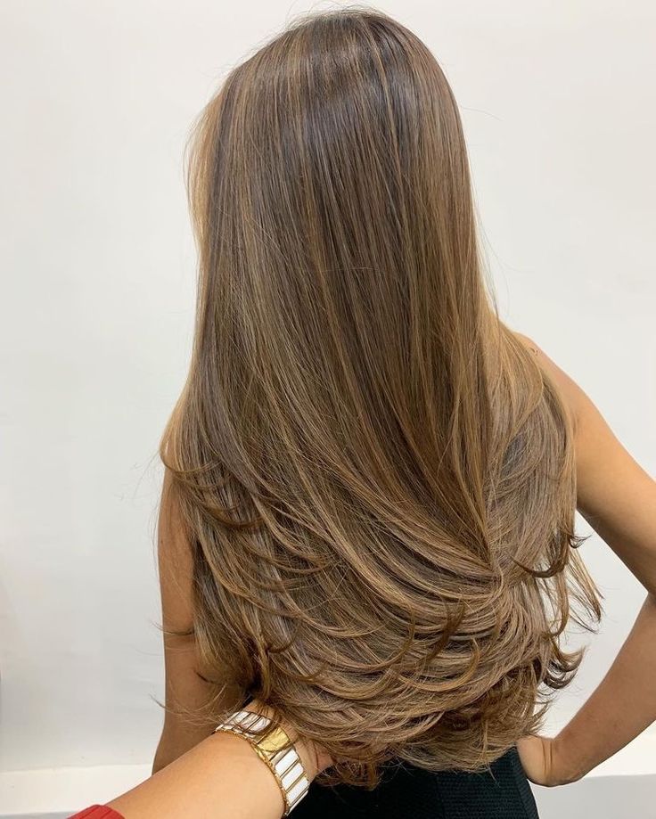 the back of a woman's head with long brown hair