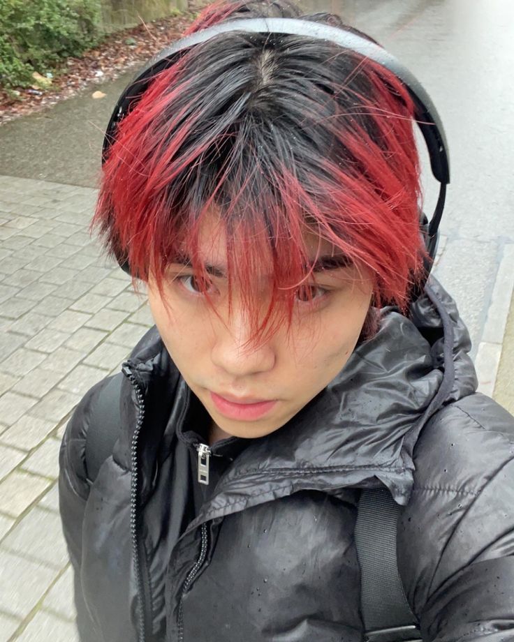 asian handsome model with red hair in the raib wearing a ouffer jacket Black Hair Red Tips, Black Roots Red Hair, Boys Dyed Hair, Pelo Color Borgoña, Black Hair With Red Highlights, Red Hair Tips, Red Hair Boy, Boys Colored Hair, Fade Hairstyle