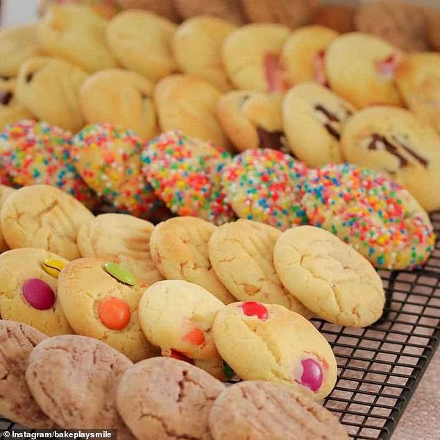 there are many cookies on the rack and one has sprinkles in it