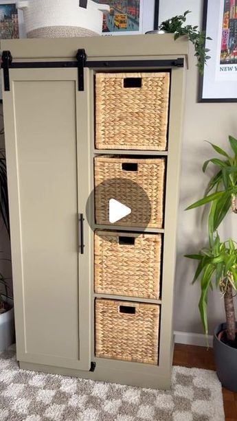 a cabinet with three wicker baskets on it and a potted plant in the corner