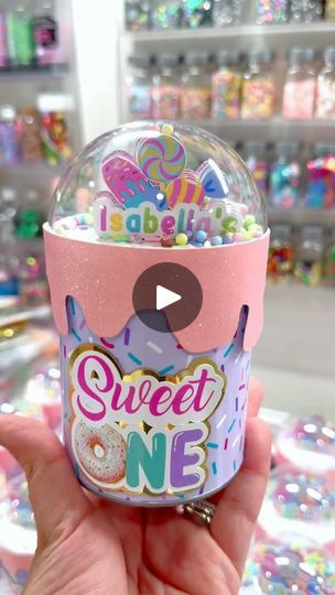 someone is holding up a gummy ball with the words sweet one on it and sprinkles