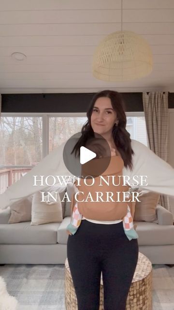 a woman standing in front of a couch with the caption how to nurse ena carrier