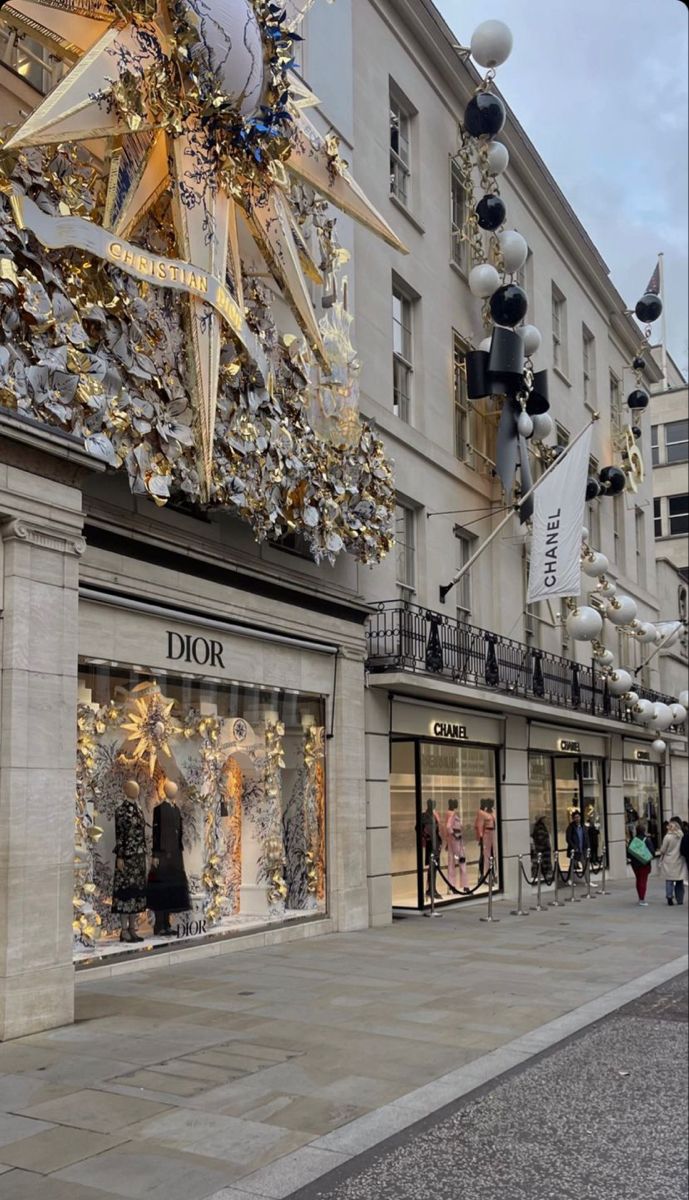 a street scene with focus on the storefronts and christmas decorations hanging from the windows